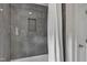 Modern tiled shower with recessed niche, white curtain rod and shower curtain at 2006 Keokuk Ct, Apex, NC 27523