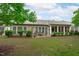 A covered patio in the backyard offers a relaxing outdoor space with mature trees and manicured bushes surrounding it at 208 Beckingham Loop, Cary, NC 27519