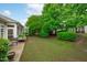 Lovely backyard featuring a patio area, lush green lawn, and well-maintained landscaping around the perimeter at 208 Beckingham Loop, Cary, NC 27519