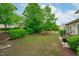 Green backyard featuring an outdoor patio seating area with an abundance of green landscape throughout at 208 Beckingham Loop, Cary, NC 27519