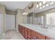 Bathroom with double sinks, cherry cabinets, and separate shower and bath at 208 Beckingham Loop, Cary, NC 27519