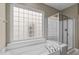 Bathroom featuring a soaking tub and glass enclosed shower at 208 Beckingham Loop, Cary, NC 27519