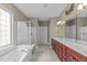 Bathroom featuring double sinks, soaking tub and glass enclosed shower at 208 Beckingham Loop, Cary, NC 27519