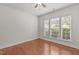 Cozy bedroom with hardwood floors, three windows offering ample natural light, and neutral paint at 208 Beckingham Loop, Cary, NC 27519