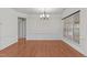Light filled dining room with wood floors, decorative trim, and a modern chandelier at 208 Beckingham Loop, Cary, NC 27519