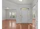 Bright foyer with gleaming hardwood floors, white trim, and views into adjacent rooms at 208 Beckingham Loop, Cary, NC 27519