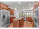 Contemporary kitchen with stainless steel appliances, wood cabinets and a large island, ideal for entertaining at 208 Beckingham Loop, Cary, NC 27519