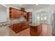 Bright kitchen featuring wood cabinets, stainless steel appliances, and an island with a granite countertop at 208 Beckingham Loop, Cary, NC 27519