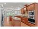 Well-lit kitchen with stainless steel appliances, wood cabinets, and an island for food prep at 208 Beckingham Loop, Cary, NC 27519