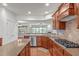 Well-equipped kitchen featuring stainless steel appliances, wood cabinets, and ample counter space at 208 Beckingham Loop, Cary, NC 27519