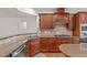 Kitchen featuring wood cabinets, stainless steel appliances and granite countertops with an eat-in counter at 208 Beckingham Loop, Cary, NC 27519