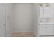Bright laundry room with a sink, cabinets, and access to the exterior at 208 Beckingham Loop, Cary, NC 27519