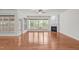 Bright living room boasts hardwood floors, a fireplace, large windows, and a ceiling fan at 208 Beckingham Loop, Cary, NC 27519