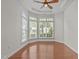 Cozy living room with hardwood floors, large windows, and a ceiling fan for comfortable living at 208 Beckingham Loop, Cary, NC 27519