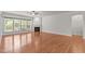 Bright living room features hardwood floors, a fireplace, and large windows, offering natural light at 208 Beckingham Loop, Cary, NC 27519