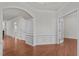 Inviting living room featuring hardwood floors, wainscoting and trim, and french doors at 208 Beckingham Loop, Cary, NC 27519