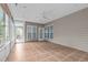 Spacious sunroom featuring tile floors, a fan, lots of windows, and outdoor access for seamless indoor-outdoor living at 208 Beckingham Loop, Cary, NC 27519