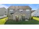 This backyard has mature landscaping, a grill, patio, and lush lawn at 2096 Dowell Ct, Burlington, NC 27215