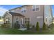 The house's rear exterior showcases a patio, lush lawn, mature landscaping and grill at 2096 Dowell Ct, Burlington, NC 27215