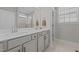 Bright bathroom with a double sink vanity with white countertop and a framed glass shower at 2096 Dowell Ct, Burlington, NC 27215