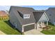 Aerial view showcasing the home's garage, charming porch, and well-manicured lawn at 2096 Dowell Ct, Burlington, NC 27215