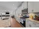Modern kitchen featuring stainless steel appliances, granite countertops, and views into the living room at 2096 Dowell Ct, Burlington, NC 27215