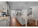 Spacious kitchen with white cabinets, granite countertops, stainless steel appliances, and a large center island at 2096 Dowell Ct, Burlington, NC 27215