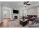 Relaxing living room with fireplace, ceiling fan, and comfortable seating arrangement at 2096 Dowell Ct, Burlington, NC 27215