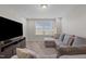 Carpeted living room features a couch and a window with blinds at 2096 Dowell Ct, Burlington, NC 27215