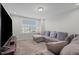 Carpeted living room features a couch and a window with blinds at 2096 Dowell Ct, Burlington, NC 27215