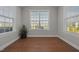 Bright sunroom featuring large windows, wood floors, and a serene atmosphere at 2096 Dowell Ct, Burlington, NC 27215