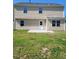 A view of the backyard and back exterior of the home with a concrete patio and siding at 2121 Lime St, Durham, NC 27704