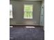 Bright bedroom featuring neutral walls, plush carpeting, and natural light from the double-hung windows at 2121 Lime St, Durham, NC 27704