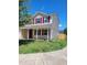 Two-story home showcasing red shutters, covered porch, and a well-maintained front yard at 2121 Lime St, Durham, NC 27704