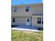 Rear view of a beige two story house, with a concrete patio and lawn at 2121 Lime St, Durham, NC 27704