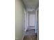 Hallway featuring carpet and multiple doorways to rooms at 2121 Lime St, Durham, NC 27704