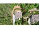Overhead aerial view shows a home and its backyard nestled in a wooded neighborhood at 216 Colonial Ridge Dr, Pittsboro, NC 27312