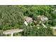 Aerial view of a house and wooded surroundings, highlighting the lot size and setting at 216 Colonial Ridge Dr, Pittsboro, NC 27312