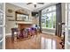 Entertaining bar area with hardwood floors, ample seating, and natural light at 216 Colonial Ridge Dr, Pittsboro, NC 27312