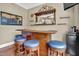 Entertaining bar area with hardwood floors, ample seating, and well-stocked shelves at 216 Colonial Ridge Dr, Pittsboro, NC 27312