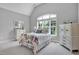 Bright bedroom with large windows, vaulted ceilings, and neutral decor at 216 Colonial Ridge Dr, Pittsboro, NC 27312