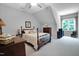 Charming bedroom features a comfortable bed, carpeted floors, and a large window with natural light at 216 Colonial Ridge Dr, Pittsboro, NC 27312