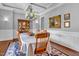 Elegant dining room with coffered ceilings, chandelier, wood floors, and wooden chairs at 216 Colonial Ridge Dr, Pittsboro, NC 27312