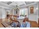 Elegant dining room features hardwood floors, coffered ceilings, and bright natural light from large windows at 216 Colonial Ridge Dr, Pittsboro, NC 27312
