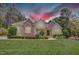 Beautiful home featuring stone accents, manicured lawn, and professional landscaping at 216 Colonial Ridge Dr, Pittsboro, NC 27312