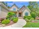 Attractive home with stone and siding, an inviting entrance, and a well-maintained lawn at 216 Colonial Ridge Dr, Pittsboro, NC 27312