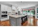 Modern kitchen with large island, granite countertops, stainless appliances, and open floor plan at 216 Colonial Ridge Dr, Pittsboro, NC 27312