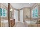 Well-appointed main bathroom with dual sinks, a soaking tub, and a separate glass-enclosed shower at 216 Colonial Ridge Dr, Pittsboro, NC 27312