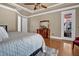 Bright main bedroom featuring a tray ceiling, wood floors, and a door leading to the backyard at 216 Colonial Ridge Dr, Pittsboro, NC 27312