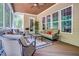 Relaxing sunroom with wicker furniture, wood ceiling, and bright windows, perfect for enjoying nature at 216 Colonial Ridge Dr, Pittsboro, NC 27312